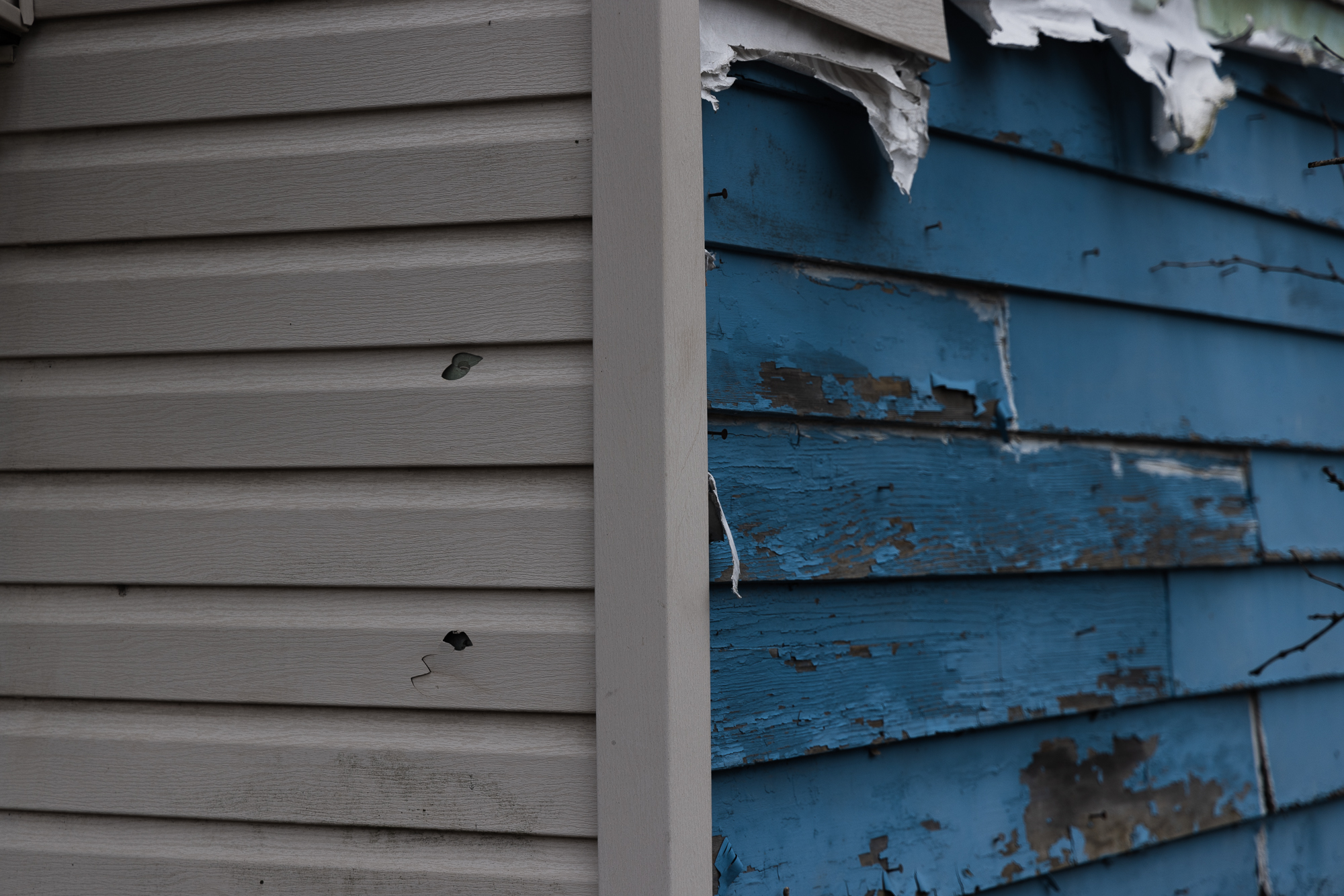 Falling siding exposes chipping lead paint on an abondoned house in Fair's neighborhood.